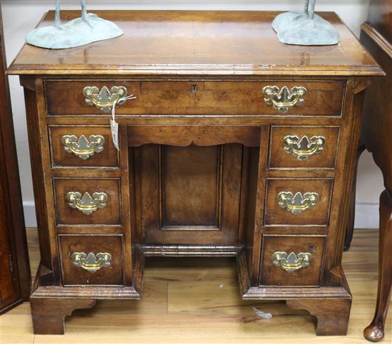 A George II style featherbanded walnut kneehole desk, W.86cm